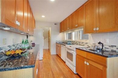 Kitchen ~ hardwood floors, granite counters, glass