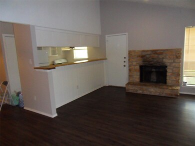 Unfurnished living room with dark wood finished f
