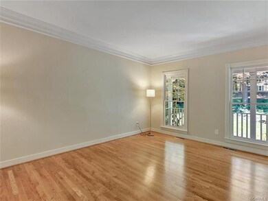 Another view of living room, with near floor to ce