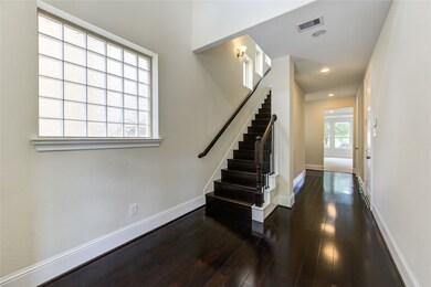 This entryway features dark hardwood floors and a