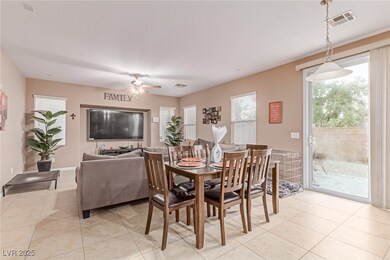 Dining room featuring a ceiling fan and light tile