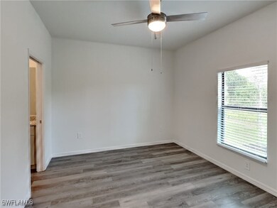 Spare room with hardwood / wood-style flooring and