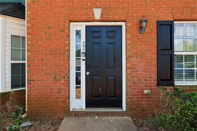 View of exterior entry with brick siding