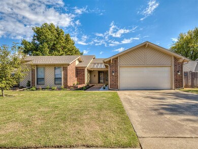 Ranch-style house with a garage and a front lawn