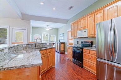 Kitchen view with granite countertops, and back of