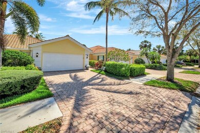 View of front of property featuring a garage, a ti