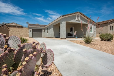 Single story home with stucco siding, driveway, an