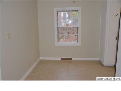 Large eating space in kitchen with tile floor.