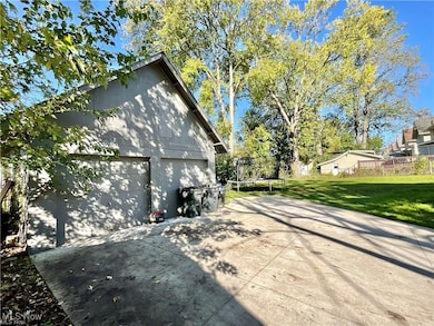 View of property exterior featuring a trampoline and a lawn