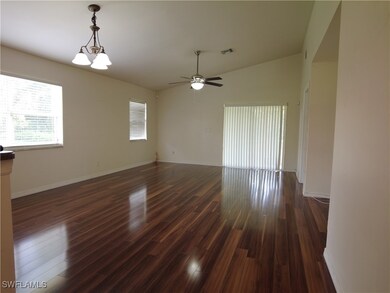 Empty room featuring vaulted ceiling, ceiling fan