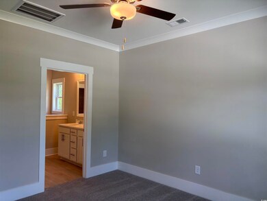 Unfurnished bedroom with a ceiling fan and light colored carpet