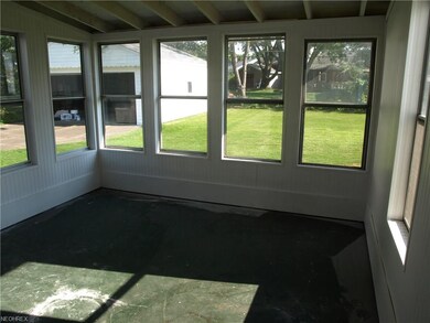 Lovely freshly painted sun room with new roof!