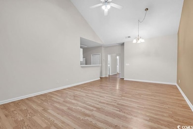 Unfurnished living room featuring ceiling fan with