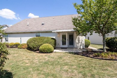 Private back yard with manicured landscaping and a covered patio
