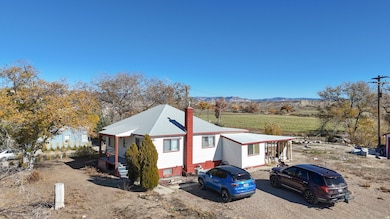 View of front of house featuring a view of rural / pastoral area, a chimney, and a mountain view