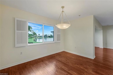 Spare room featuring hardwood / wood-style floors and baseboards