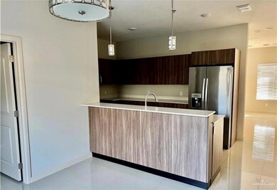 Kitchen featuring stainless steel fridge with ice dispenser, light countertops, visible vents, modern cabinets, and light tile patterned flooring