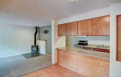 Kitchen with stainless steel appliances, a wood st
