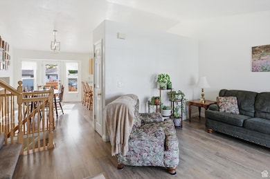Living room with stairway and wood finished floors