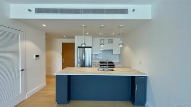 Kitchen with white cabinets, backsplash, light stone counters, appliances with stainless steel finishes, and recessed lighting
