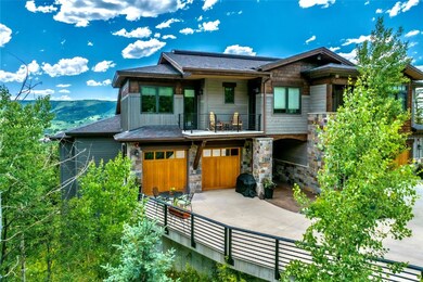 View of front facade with a balcony, stone siding,