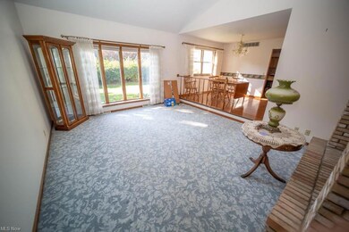Sitting room behind brick wall of foyer w/fireplac