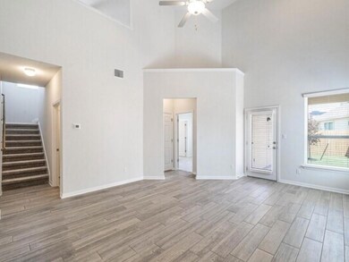 Unfurnished living room featuring high vaulted ce