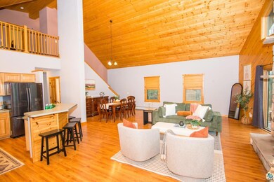 Living area featuring high vaulted ceiling, light 