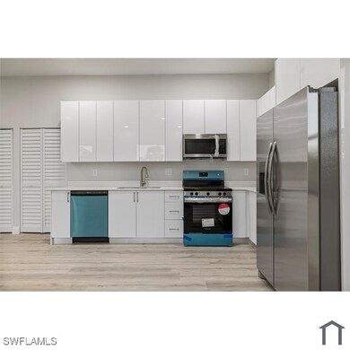 Kitchen with modern cabinets, a sink, white cabine