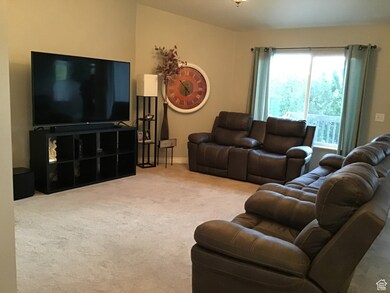 Carpeted living area with baseboards
