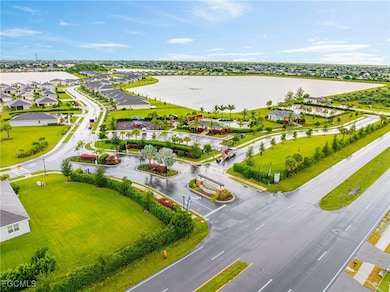 Aerial view of residential area featuring a nearby body of water