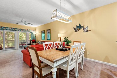 Dining area with carpet floors, ceiling fan, and b