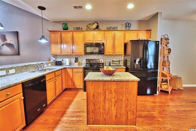 Wood cabinetry, granite countertops, a center isla