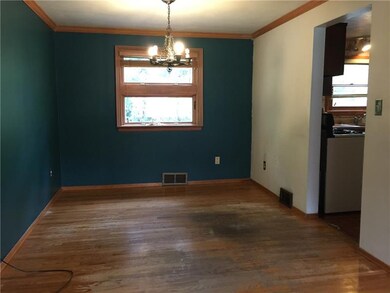 Formal dining  with a hardwood floor and crown mol
