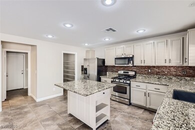 Kitchen featuring visible vents, decorative backsp
