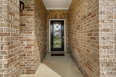 Front entry with brick surround.