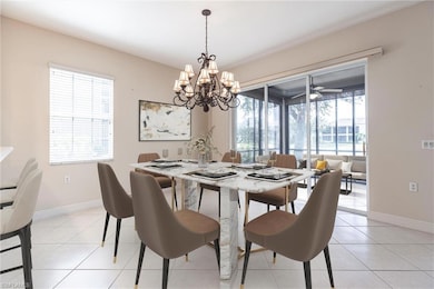 Dining space with light tile patterned flooring and a chandelier
