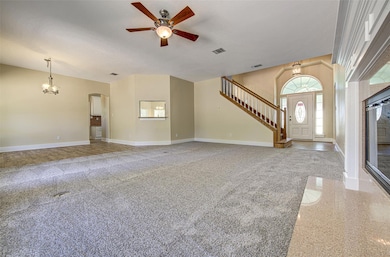 Unfurnished living room featuring a ceiling fan, 
