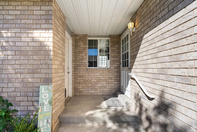 Entrance to property with brick siding