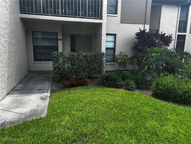 Entrance to property with stucco siding and a lawn