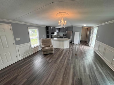 Living area featuring a chandelier, a textured cei