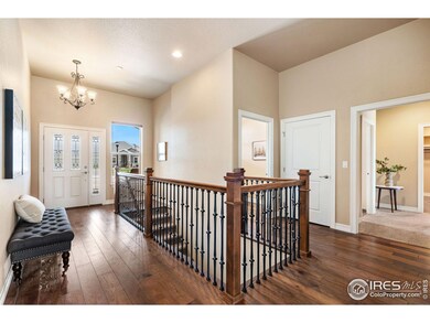 Foyer area with a wide stair case to the basement.