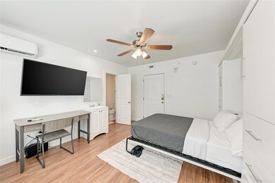 Bedroom featuring a wall mounted air conditioner,