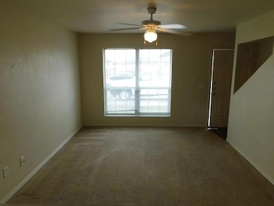 Unfurnished room featuring carpet flooring and ceiling fan