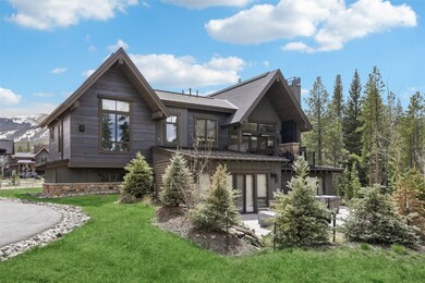 Back of property featuring a chimney, a yard, a ba