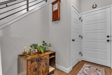 Entryway with wood finished floors and baseboards