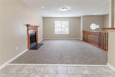 Unfurnished living room featuring carpet floors, a