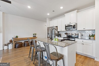 Open kitchen with an eat-in kitchen island is perfect for quick family meals or entertaining.