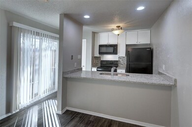 KITCHEN WITH GRANITE COUNTERTOPS AND BREAKFAST BAR