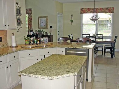 The cheery kitchen features granite countertops, n